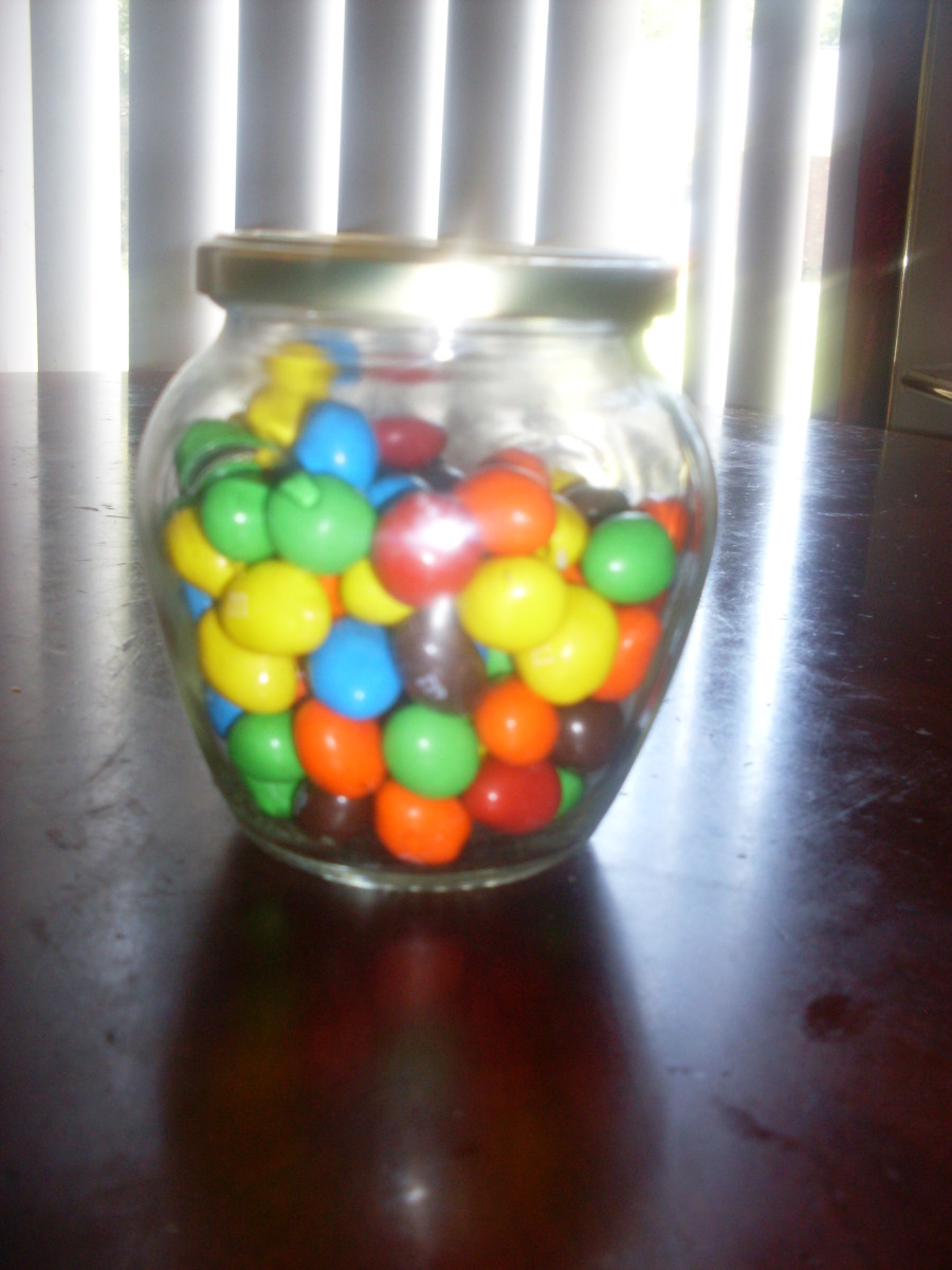 Covered glass jar of peanut M&Ms