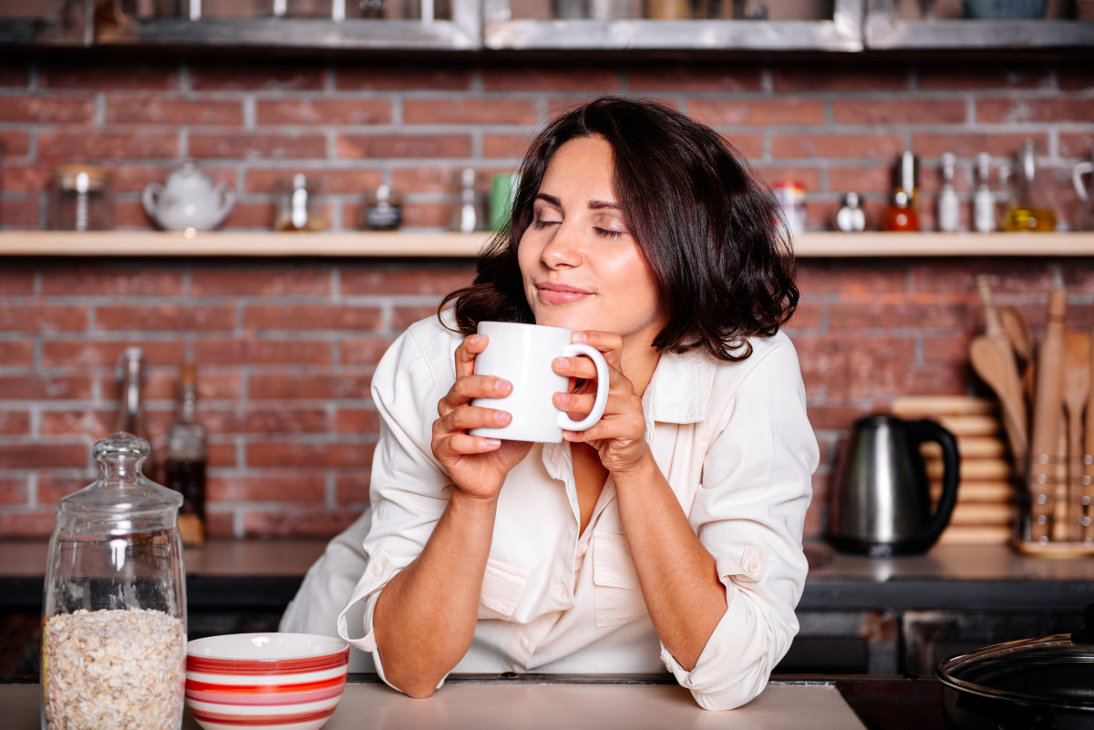 ISTOCK woman Kitchen Coffee morning. Coffee on the Kitchen. ISTOCK woman Kitchen Coffee morning domoyega. Tasting Coffee at the Kitchen woman.