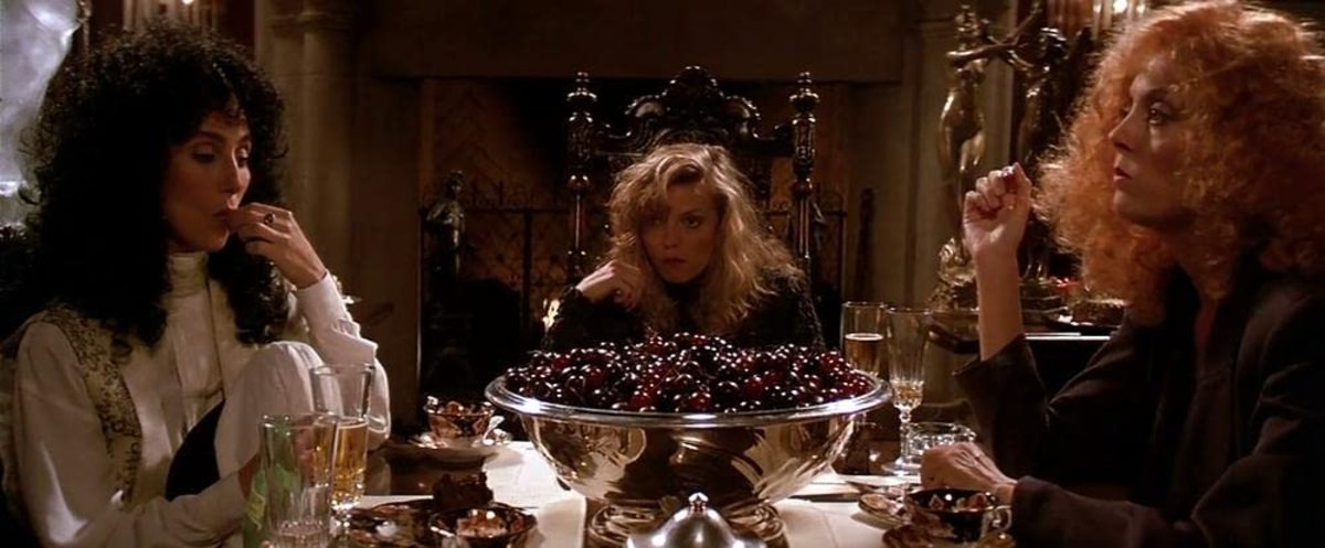 Alexandra (Cher) Sukie (Michelle Pfeiffer) and Jane indulge in a bowl of cherries and try to figure out the mysterious Daryl Van Horne