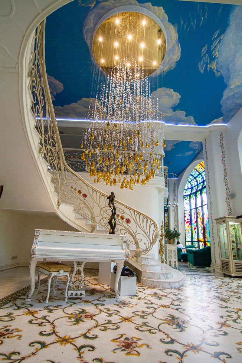 Art Nouveau is making a comeback for its focus on forms related to plants and flowers. The floor of this elaborate room plays off the Art Nouveau style. The staircase and chandelier have shapes related to the design movement.