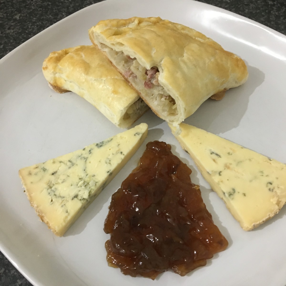 Cabbage and bacon pasty is served with cheese and chutney
