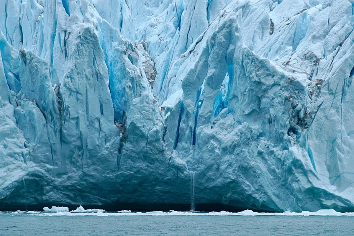 A melting iceberg illustrates the change of ice to liquid, an increase in entropy.