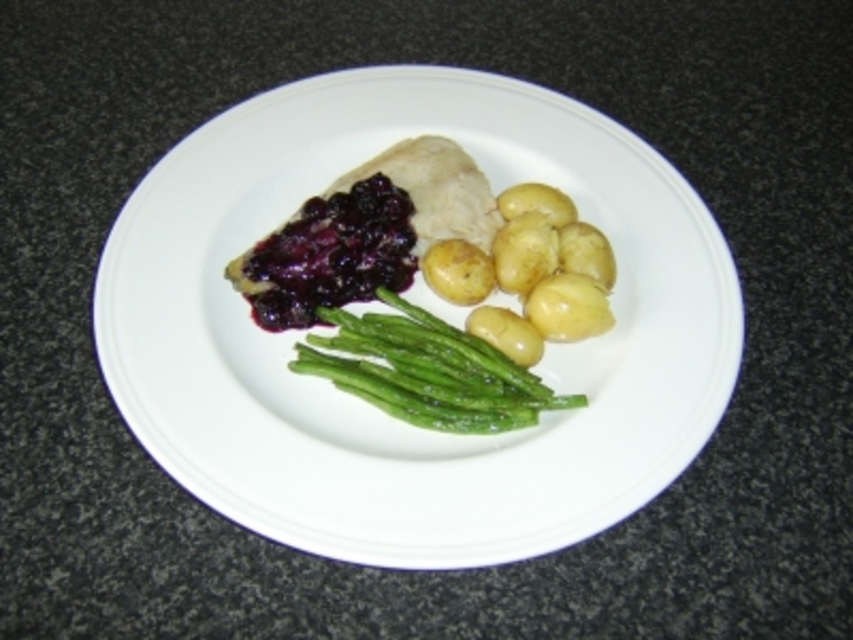 Coley fillet is simply grilled (broiled) and served with a sauce made from blueberiies and red wine