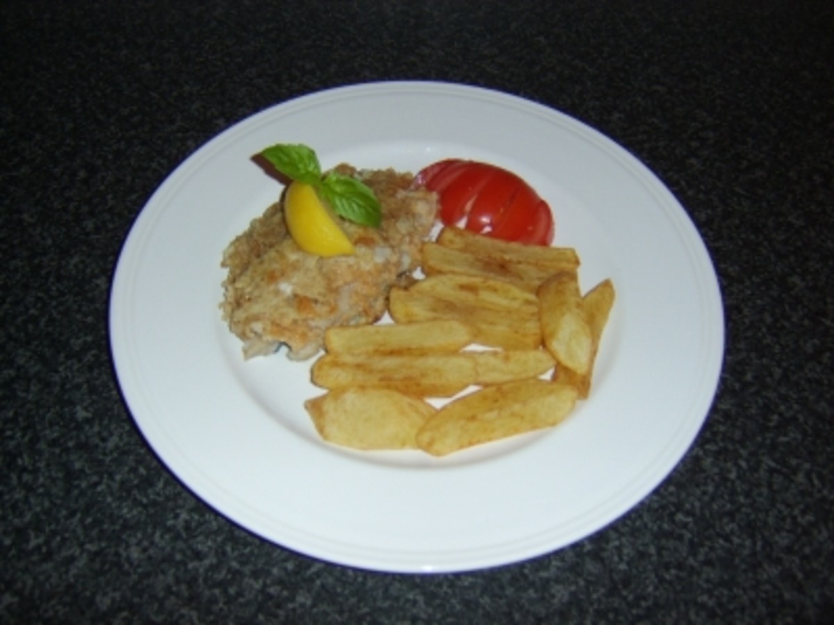 Coley fillet is shallow fried in fresh breadcrumbs and served with homemade chips