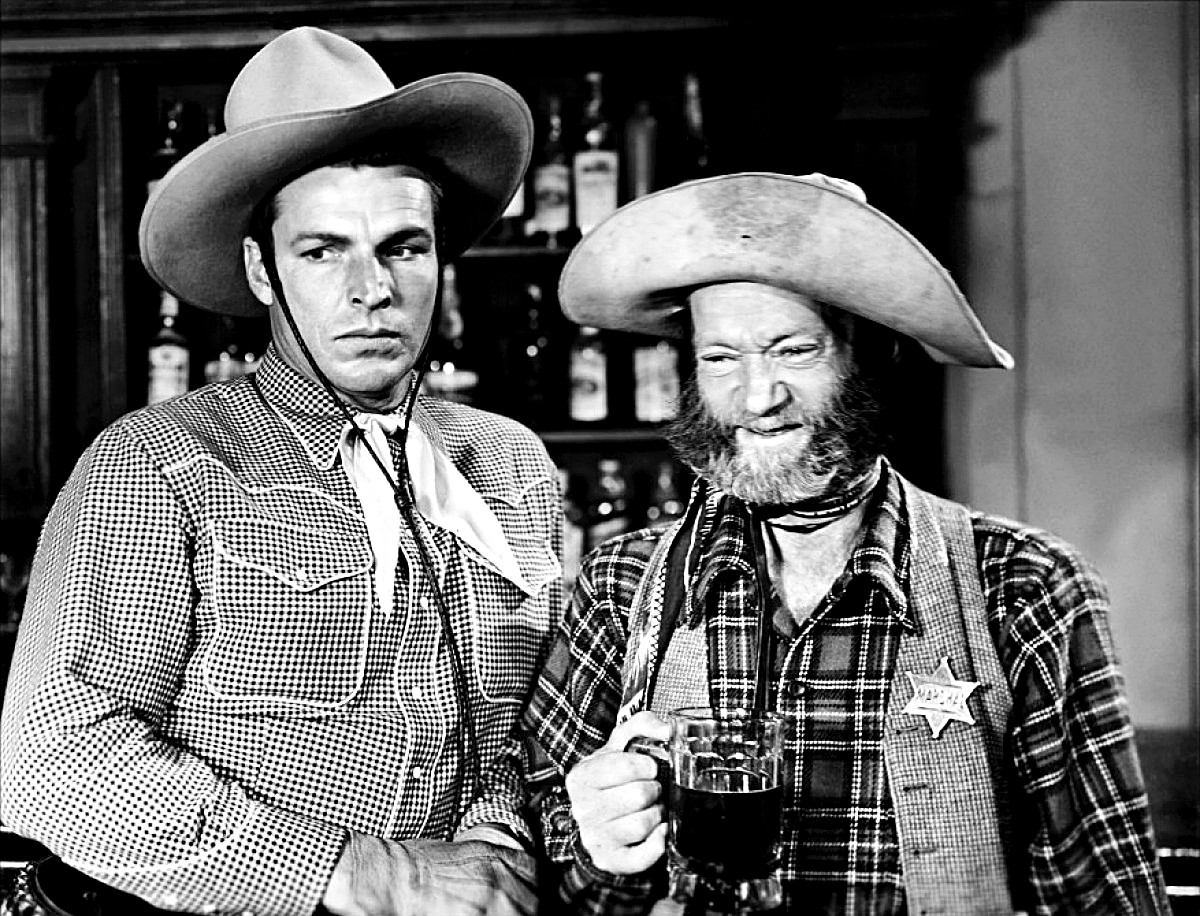 Buster Crabbe (left) and Al St. John in "Shadows of Death" (1945). St. John played Fuzzy Q. Jones, Justice of the Peace, town marshal, barber, and horse doctor.