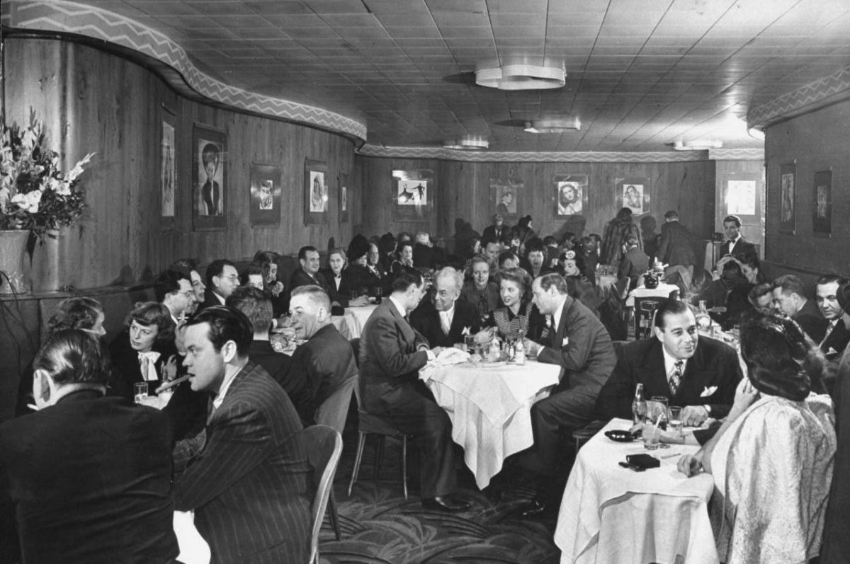 A rather stiffly posed image from the Stork Club in New York, 1944. Orson Wells is in the foreground left; Sherman Billingsley is at the centre table.