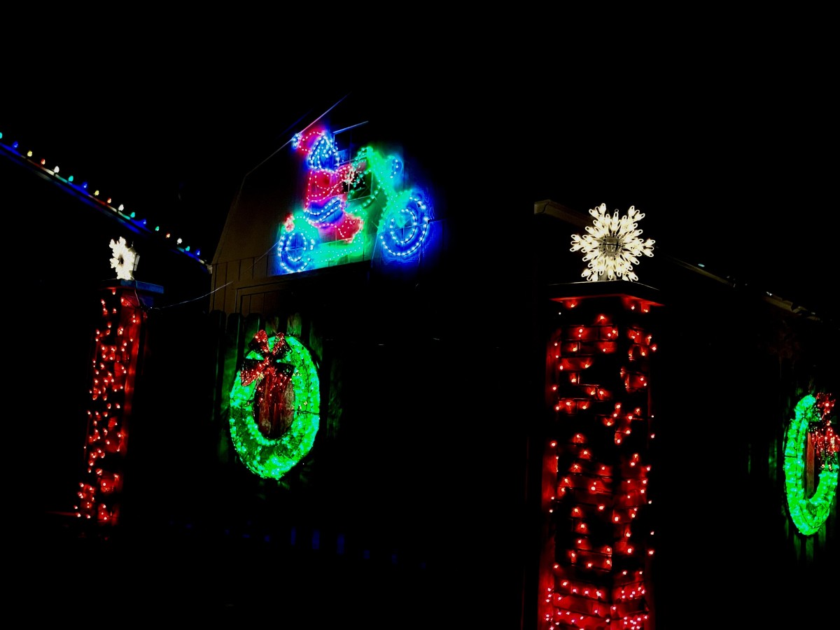 Santa on his motorcycles and lighted candles are features of this house on the corner of Prince Street and Costilla Ave.